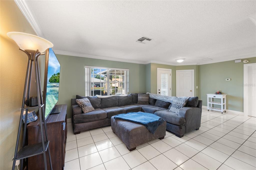 8714 Martinique Lane Port Richey, FL 34668 - Photo 10 of 34 a living room with furniture and a window