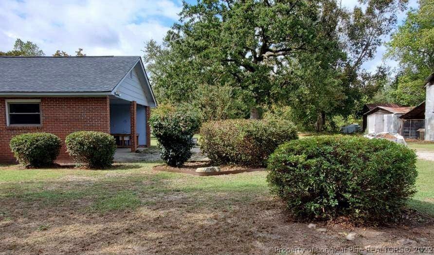 5146 Matt Hair Road Fayetteville, NC 28312 - Photo 4 of 23 a view of a house with yard and a garden