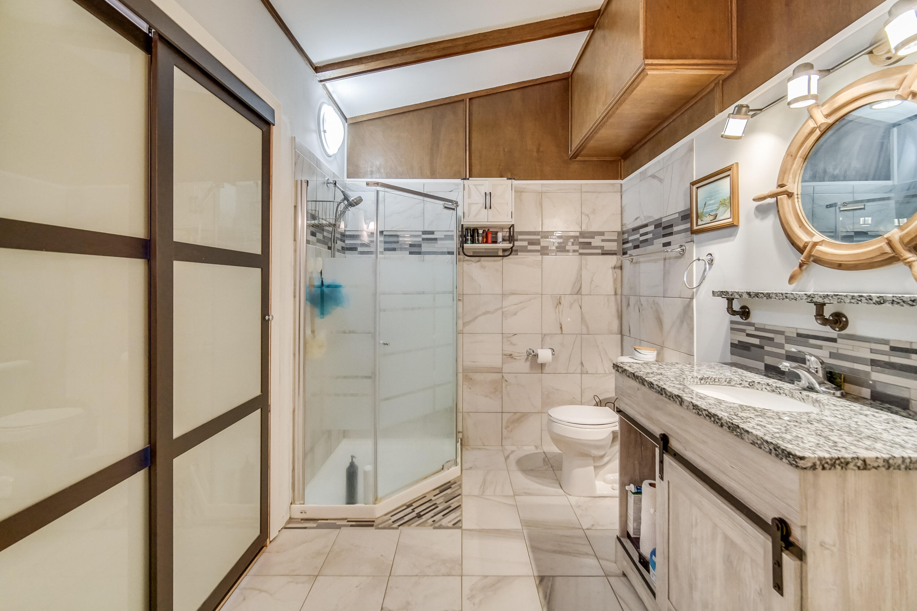 5203 Vasa Terrace Lowell, IN 46356 - Photo 13 of 33 a bathroom with a granite countertop sink toilet and a mirror