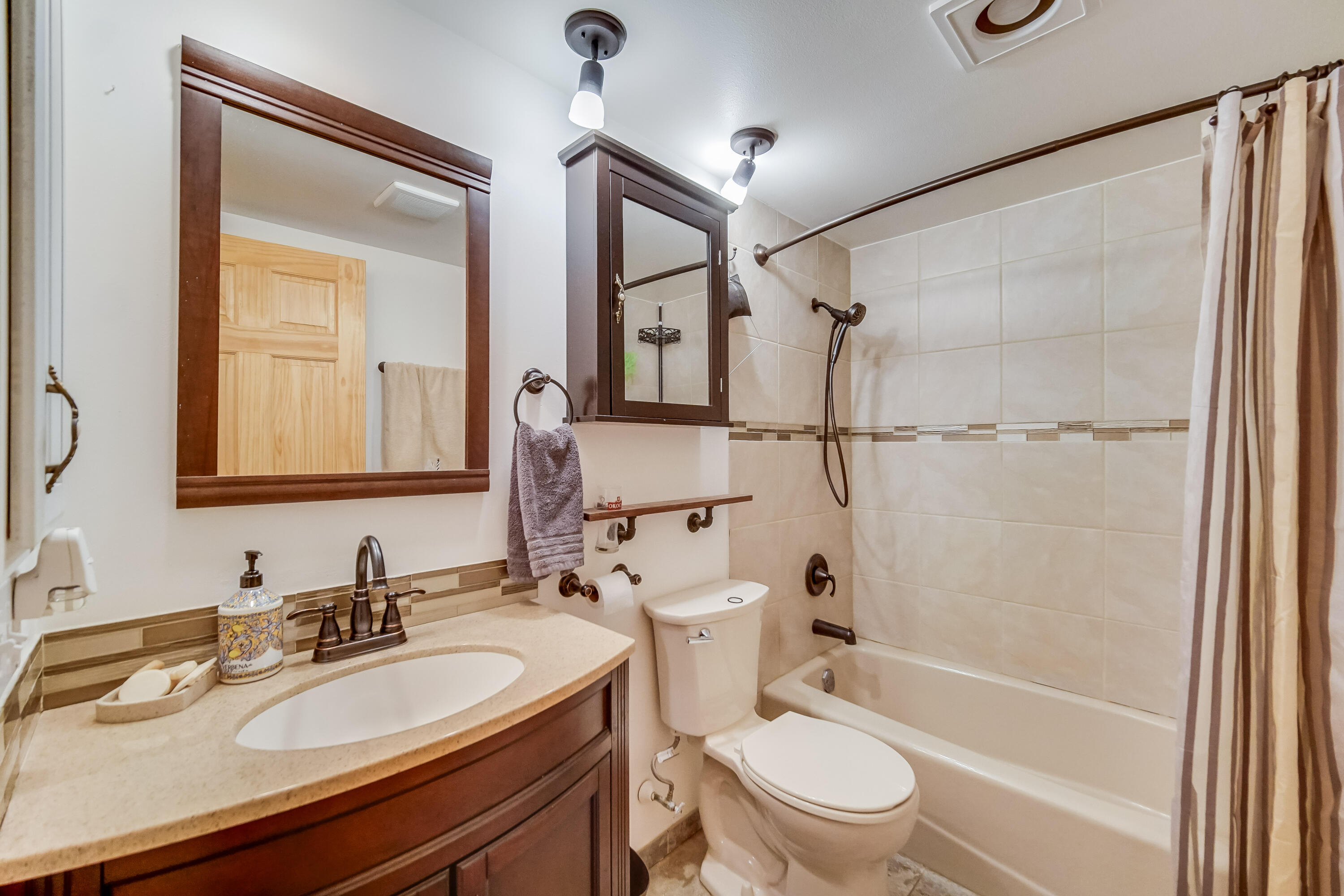 5203 Vasa Terrace Lowell, IN 46356 - Photo 15 of 33 a bathroom with a granite countertop sink toilet a mirror and shower
