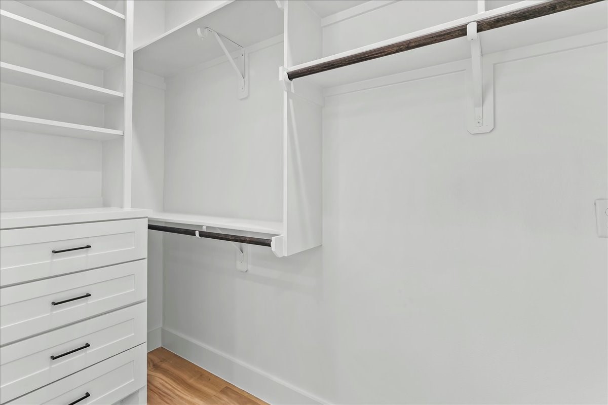8323 Observatory Street, Unit A/B Houston, TX 77088 - Photo 26 of 38 Unit B - Walk-in primary closet features custom built-in cabinetry designed to maximize storage and organization. Custom closet design may vary. Pictures are from a previous build.