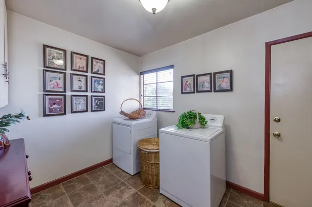 an aerial view of a house with a yard and fountain in the background