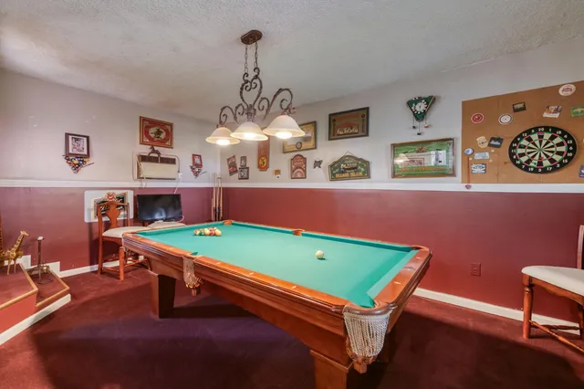 an aerial view of a house with a yard and lake view