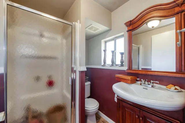 an aerial view of a house with a yard and lake view