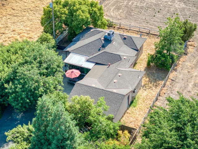 a view of a house with a yard and potted plants