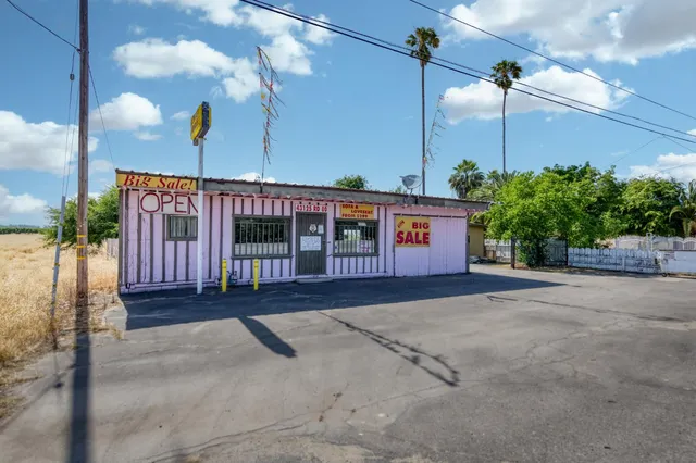 a living room with furniture gym equipment and kitchen view