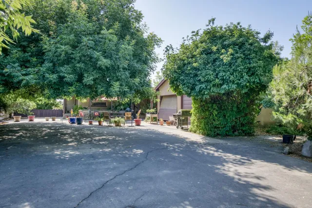 a backyard of a house with table and chairs