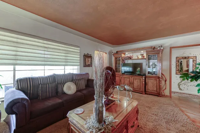a dining room with furniture a chandelier and window
