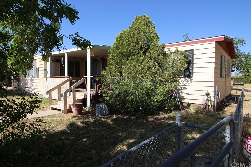 1119 South Guam Street Ridgecrest, CA 93555 - Photo 1 of 1 a front view of a house with garden