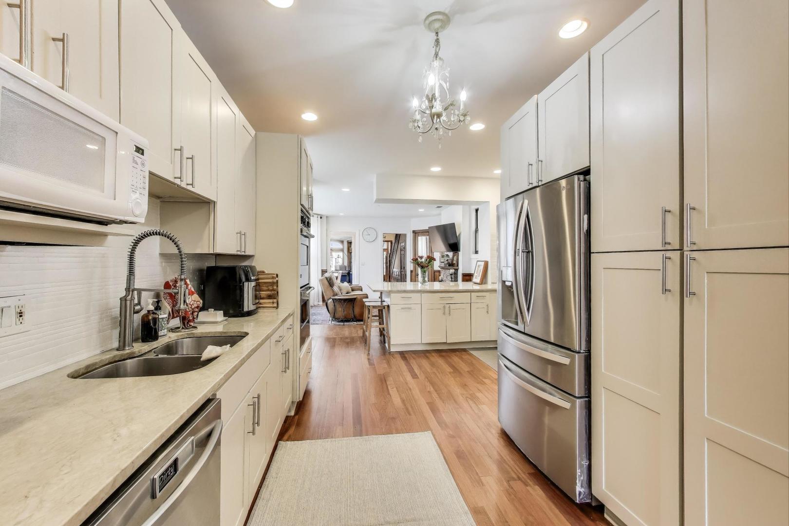 4553 South Ellis Avenue Chicago, IL 60653 - Photo 15 of 62 a kitchen with stainless steel appliances a refrigerator sink and cabinets