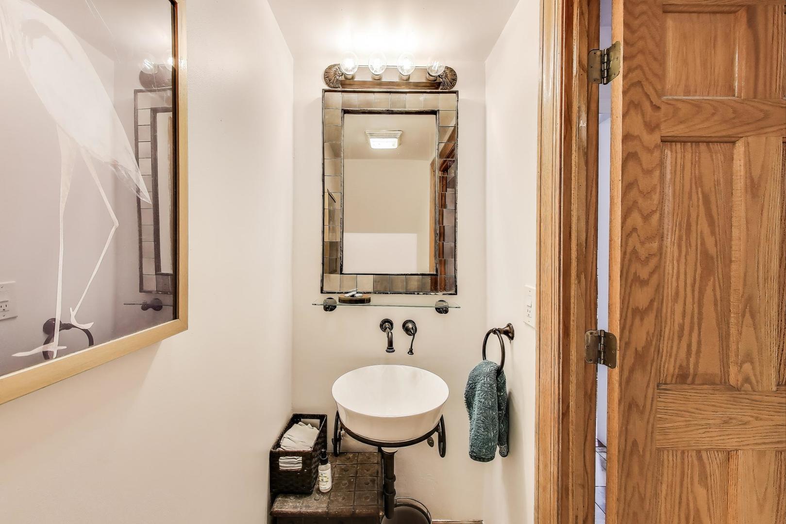 4553 South Ellis Avenue Chicago, IL 60653 - Photo 20 of 62 a bathroom with a sink a toilet and mirror