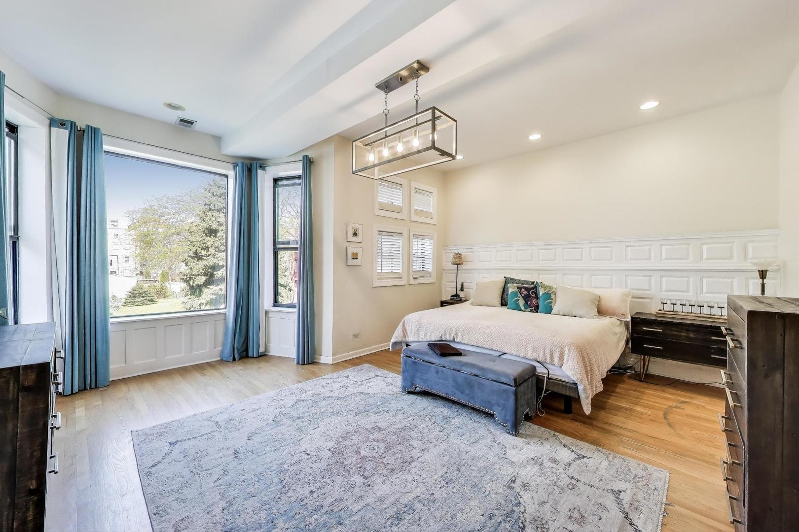 4553 South Ellis Avenue Chicago, IL 60653 - Photo 22 of 62 a spacious bedroom with a bed and window