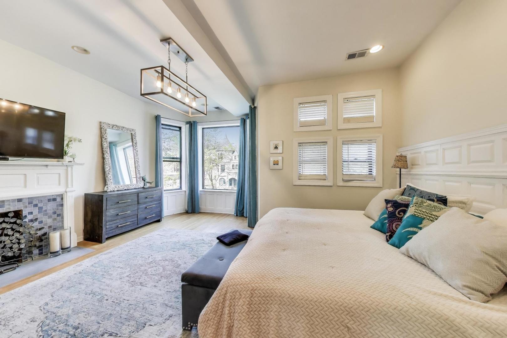 4553 South Ellis Avenue Chicago, IL 60653 - Photo 23 of 62 a bedroom with a large bed and a flat screen tv