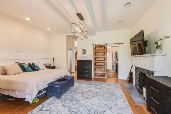 a bedroom with a bed and a chandelier