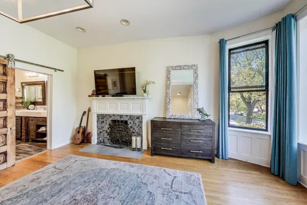 a bed sitting in a bedroom next to a window