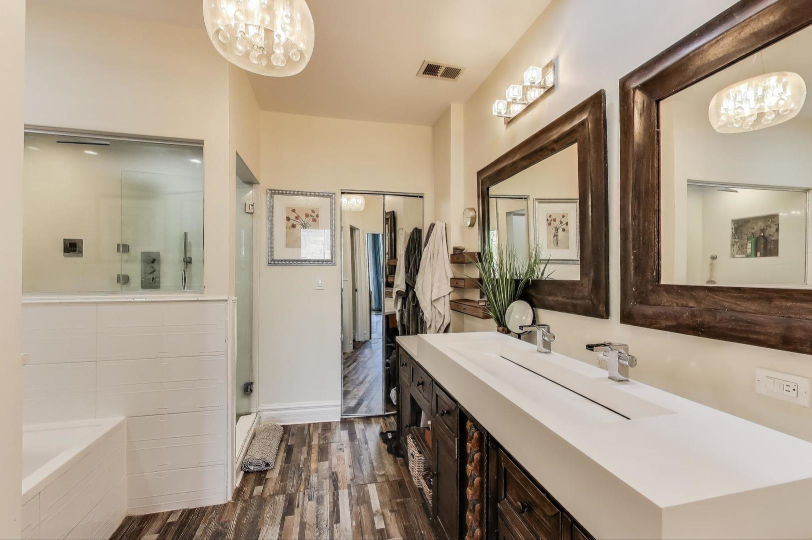 4553 South Ellis Avenue Chicago, IL 60653 - Photo 26 of 62 a bathroom with a double vanity sink a mirror and a shower