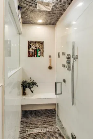 a view of a hallway with cabinet and a chandelier