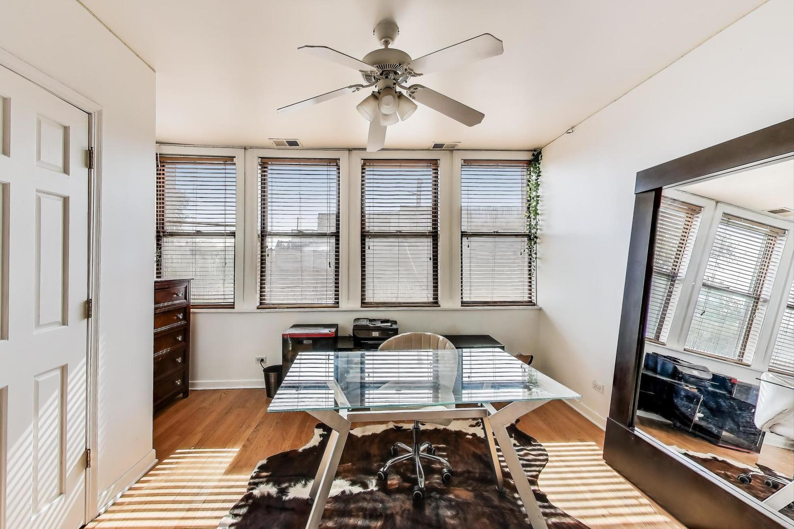 4553 South Ellis Avenue Chicago, IL 60653 - Photo 31 of 62 a bed sitting in a bedroom next to a window