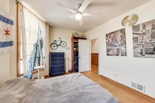 a bedroom with a bed a rug and a dresser