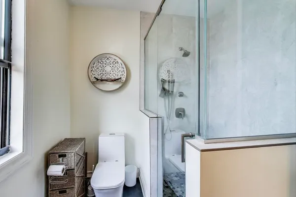 a bathroom with a sink a toilet and shower curtain
