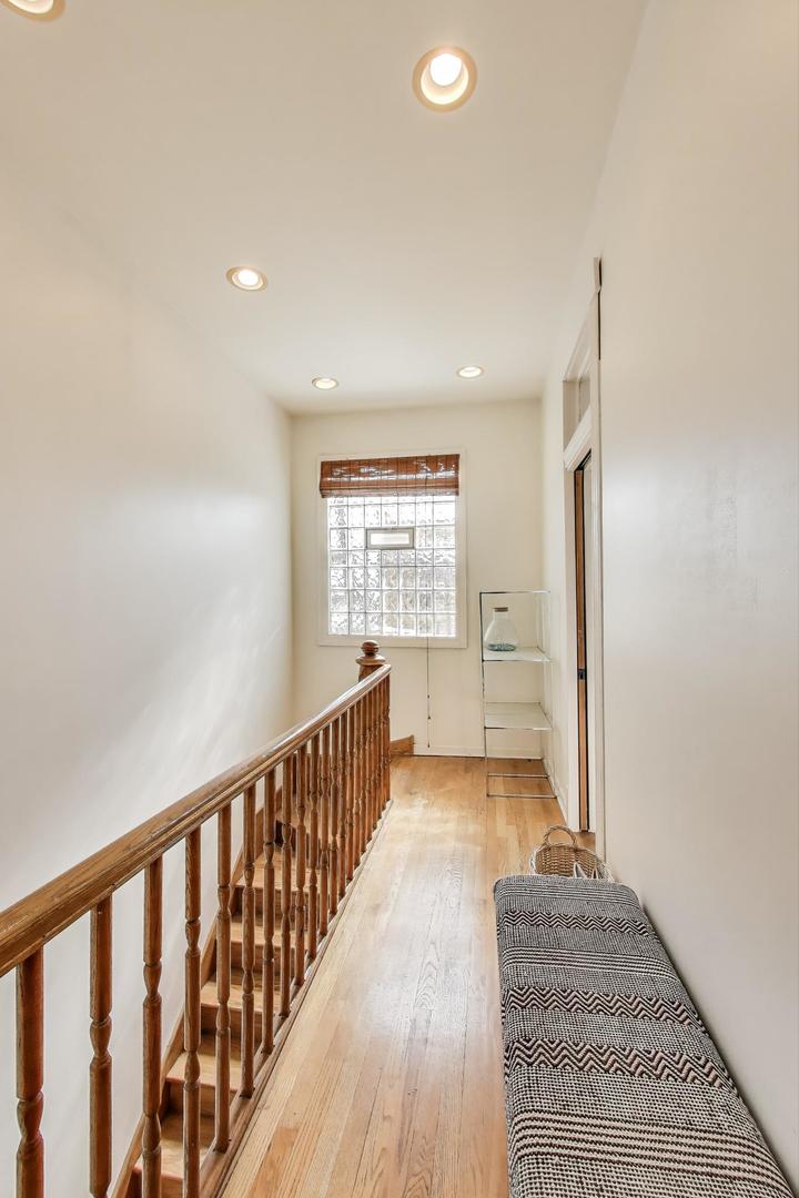 4553 South Ellis Avenue Chicago, IL 60653 - Photo 38 of 62 a view of a hallway with wooden floor and a window