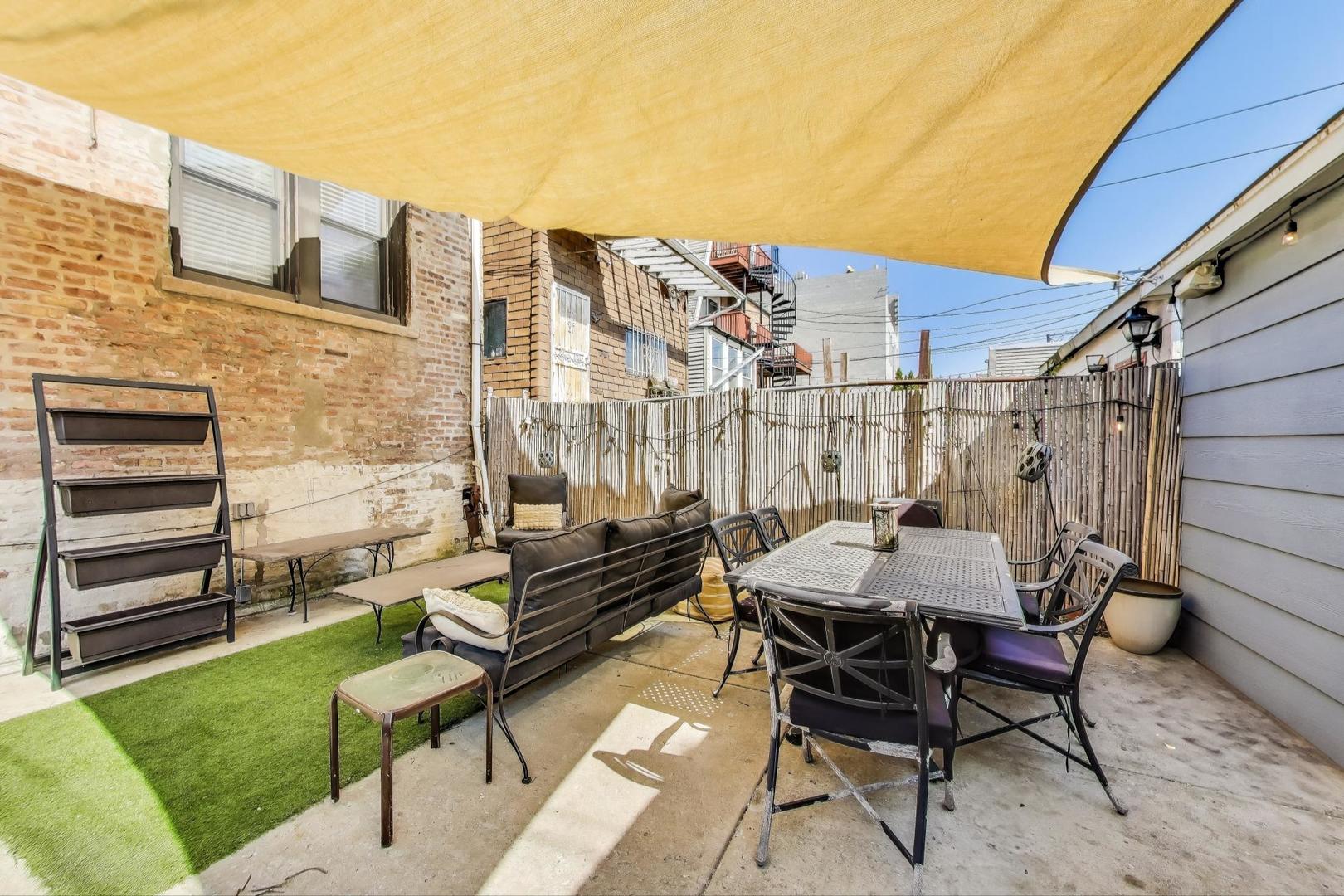 4553 South Ellis Avenue Chicago, IL 60653 - Photo 57 of 62 a patio with a table and chairs and potted plants