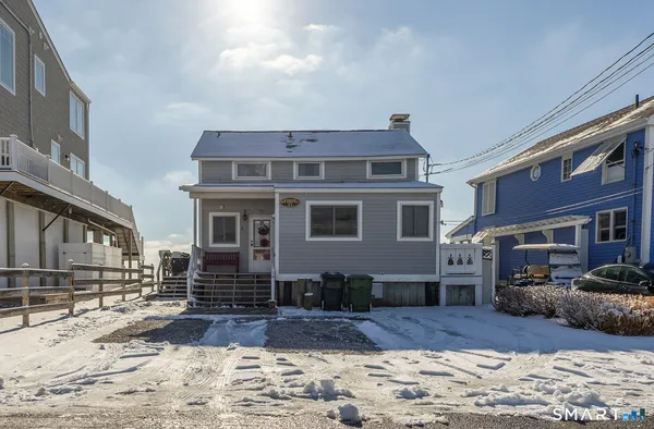 a view of a house with a yard covered in snow