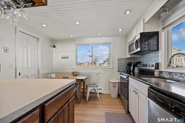 a kitchen with a refrigerator and a stove top oven