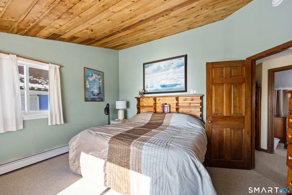 a bedroom with furniture and a window