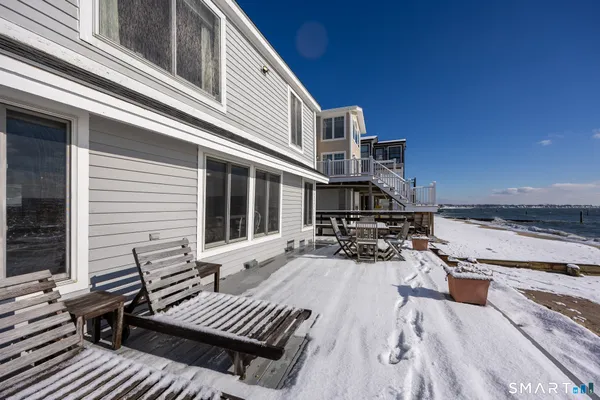 a view of a terrace with wooden floor and a ocean view