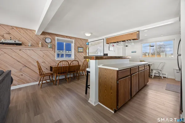 a dining room with furniture and wooden floor