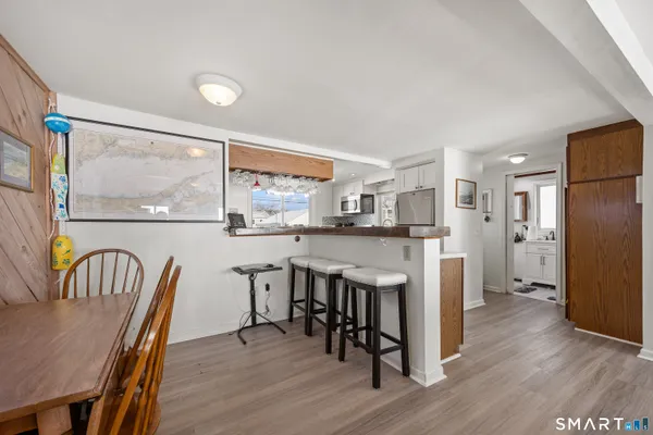 a kitchen with stainless steel appliances sink stove microwave and cabinets