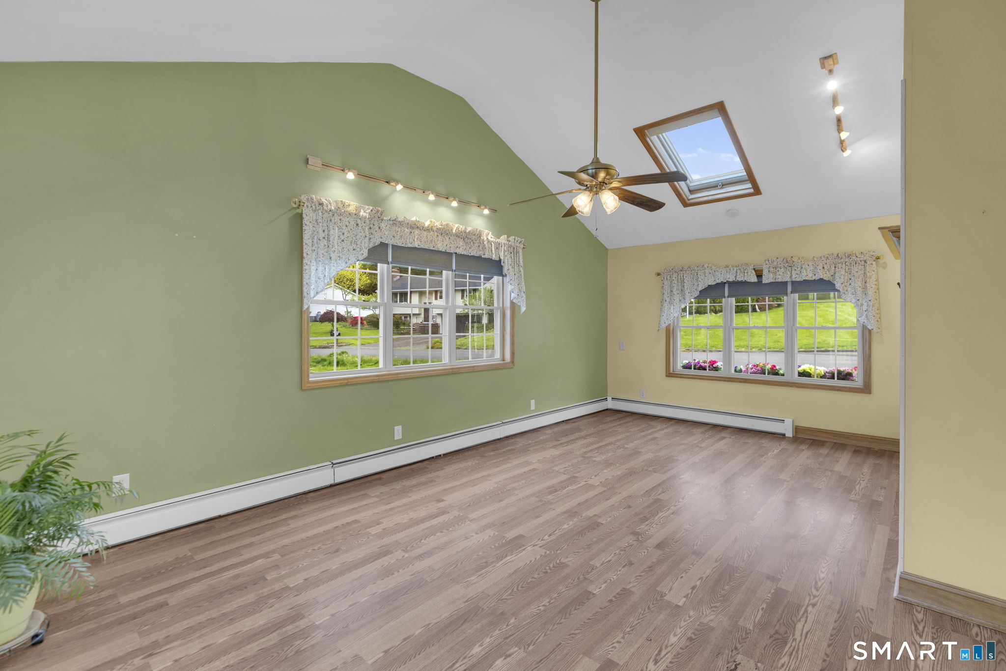 102 Wayne Lane Meriden, CT 06450 - Photo 26 of 36 an empty room with wooden floor fan and windows