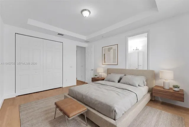 a bedroom with a bed and a couch