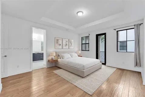 a bedroom with a large bed and a window