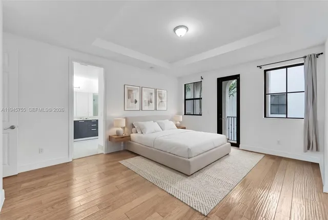 a bedroom with a large bed and a window