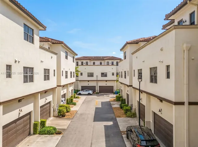 a view of a white building with many windows