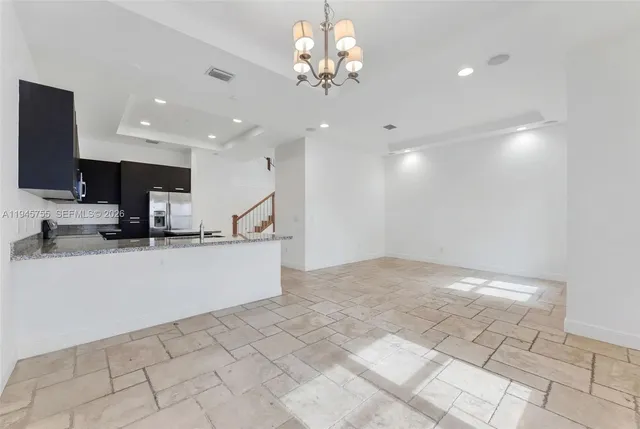 a view of kitchen with center island and stainless steel appliances