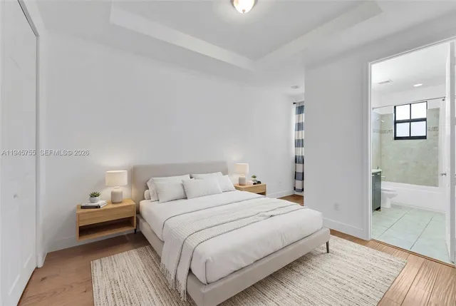 a bedroom with a bed and a view of bathroom