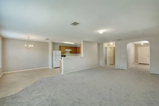 an empty room with windows and pillars in it
