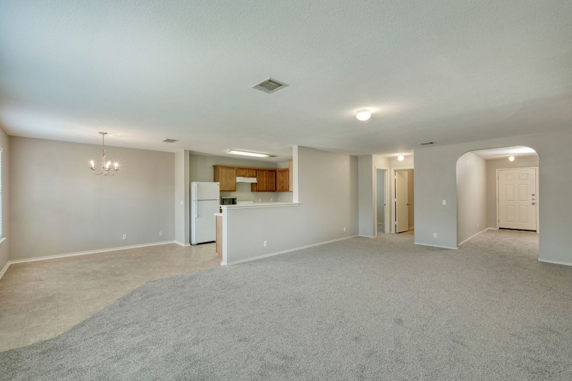 495 Atlantis Kyle, TX 78640 - Photo 2 of 14 an empty room with windows and pillars in it