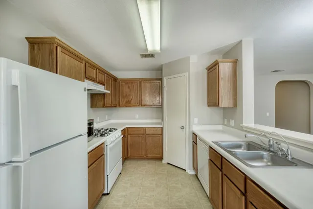 a kitchen with a sink appliances and cabinets