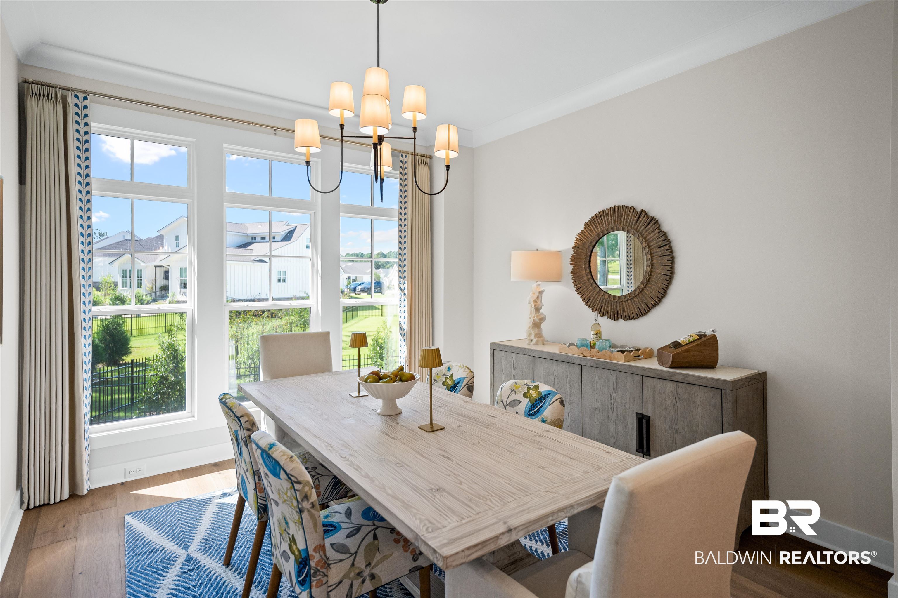 156 Hyacinth Street Fairhope, AL 36532 - Photo 23 of 61 Dining space featuring dark wood finished floors and a chandelier