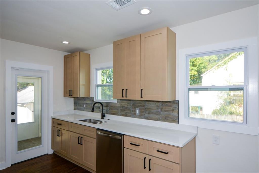 1275 Westridge Road Southwest Atlanta, GA 30311 - Photo 11 of 38 a bathroom with a double vanity sink and a window