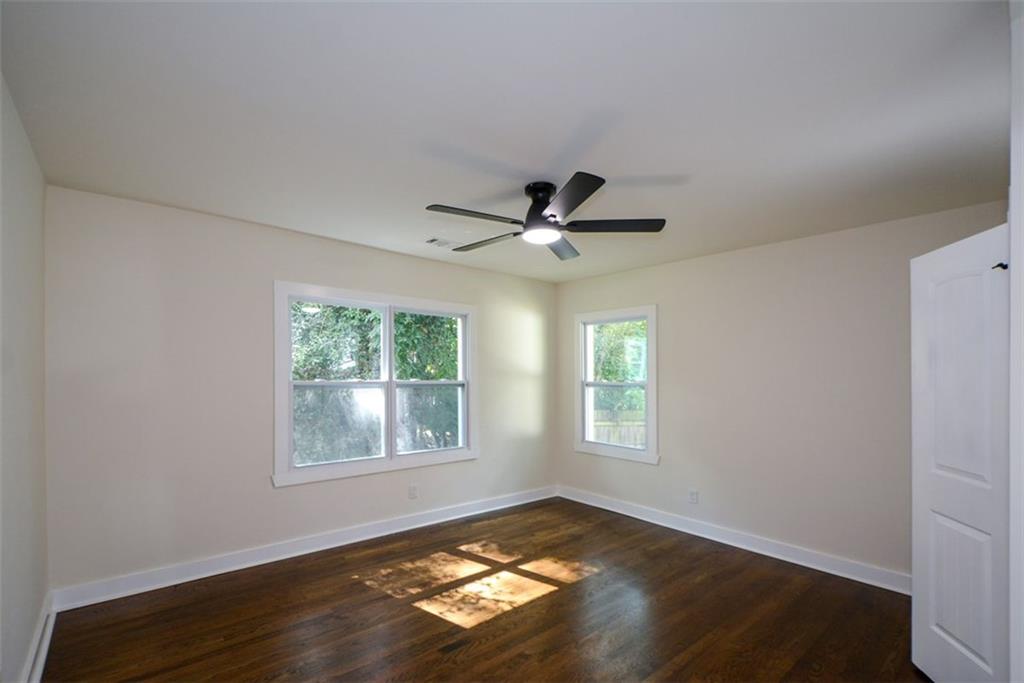 1275 Westridge Road Southwest Atlanta, GA 30311 - Photo 14 of 38 a view of an empty room with wooden floor and a window