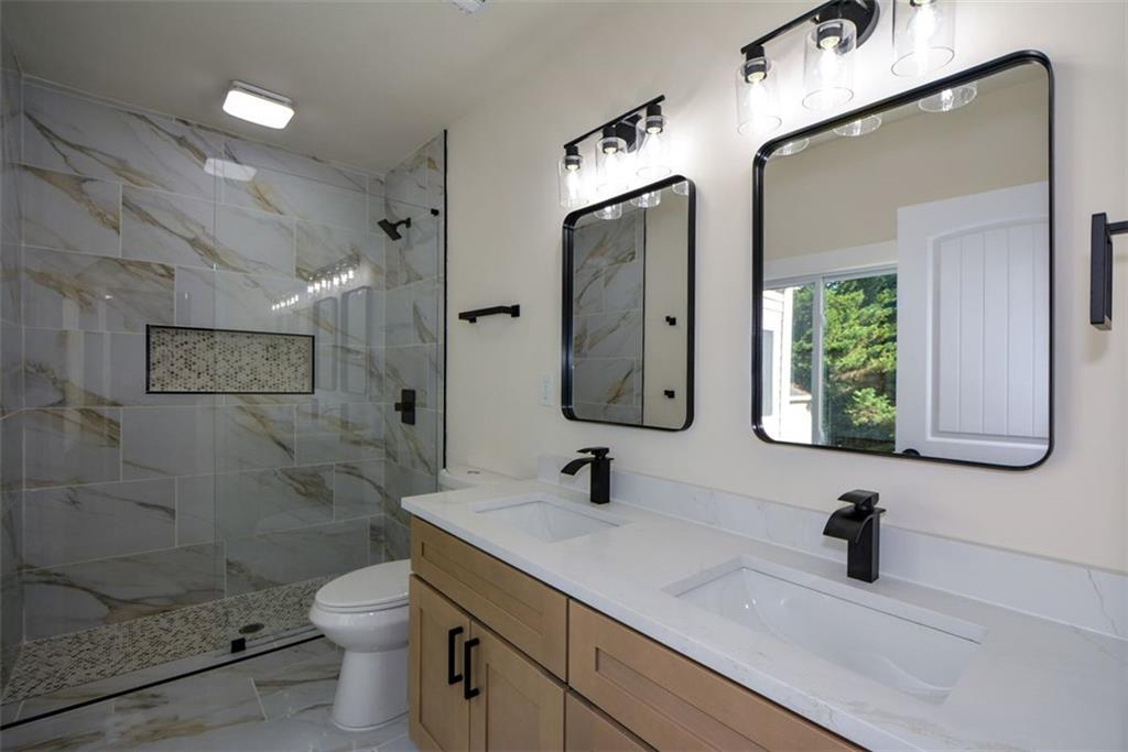 1275 Westridge Road Southwest Atlanta, GA 30311 - Photo 16 of 38 a bathroom with a sink a toilet and shower