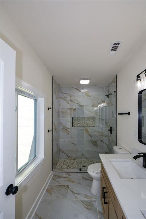 1275 Westridge Road Southwest Atlanta, GA 30311 - Photo 17 of 38 a bathroom with a granite countertop sink a toilet and shower