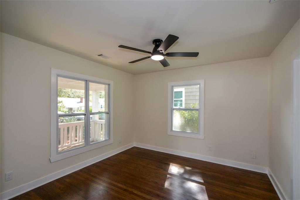 1275 Westridge Road Southwest Atlanta, GA 30311 - Photo 18 of 38 a view of an empty room with wooden floor and a window