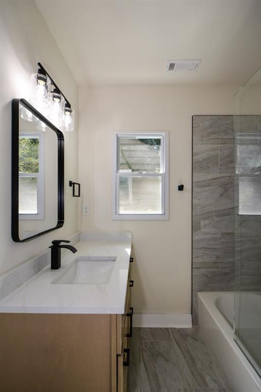 1275 Westridge Road Southwest Atlanta, GA 30311 - Photo 20 of 38 a bathroom with a sink a toilet and bathtub