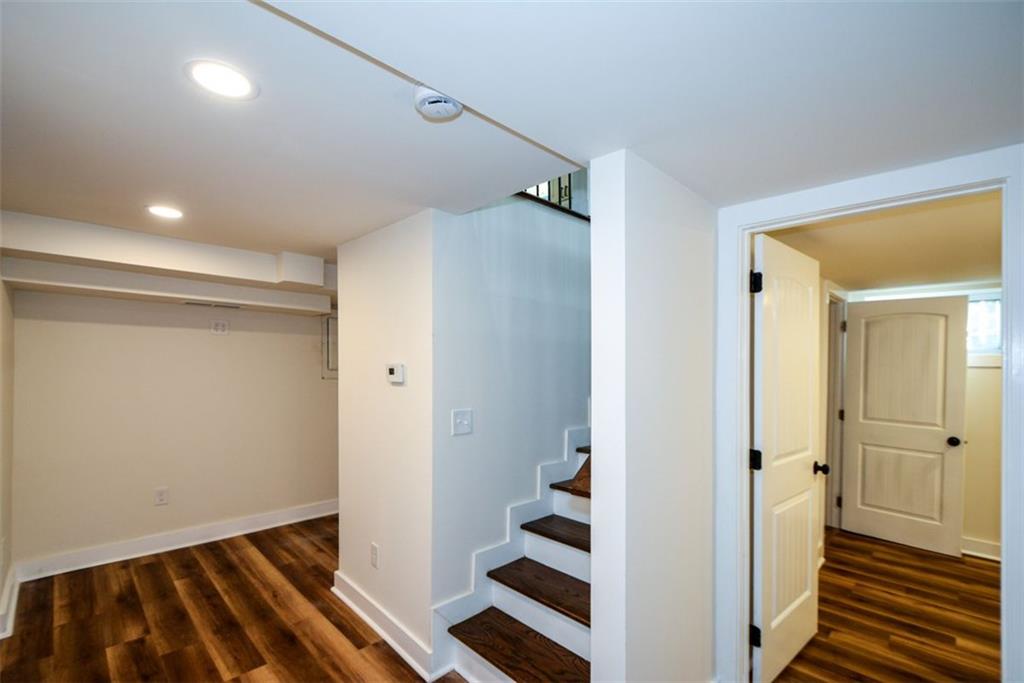 1275 Westridge Road Southwest Atlanta, GA 30311 - Photo 23 of 38 a view of a hallway with wooden floor and cabinets